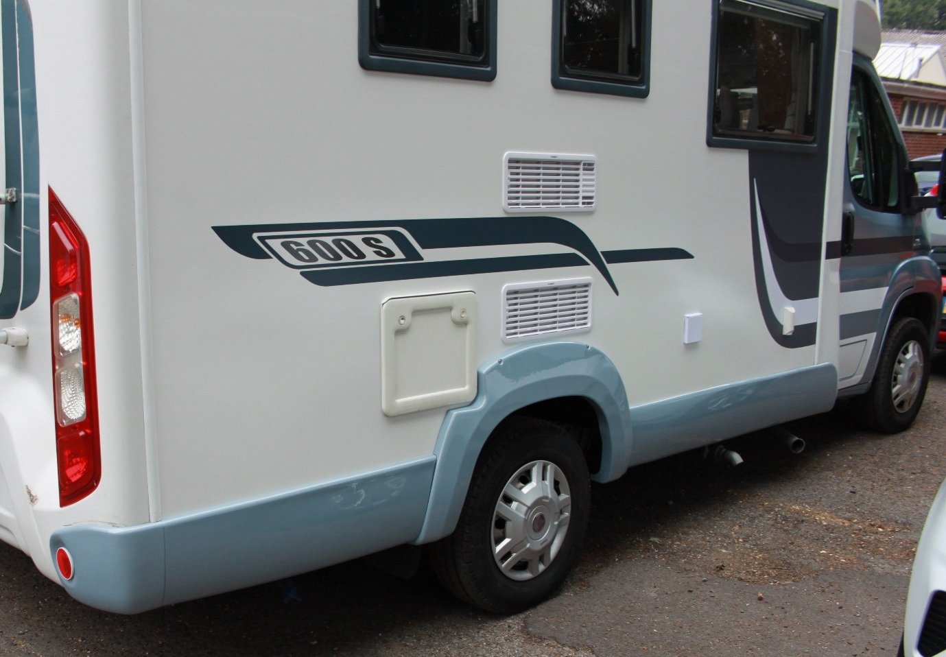 The same motorhome with the side skirt and arch fully repaired